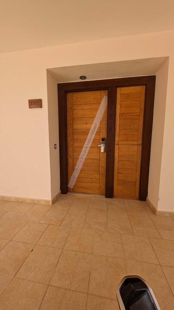 Our room door with a ribbon across it that read "It's Our Anniversary".